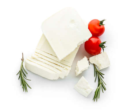 Tasty feta cheese with tomatoes and herbs on white backgroundの写真素材