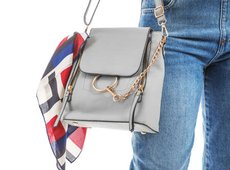 Beautiful young African-American woman with stylish bag on white backgroundの写真素材