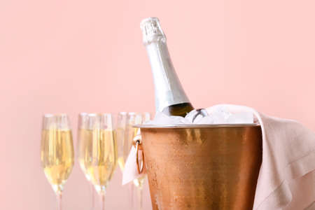 Bucket with ice and champagne on color backgroundの写真素材