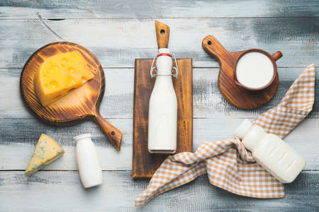 Different dairy products on wooden backgroundの写真素材