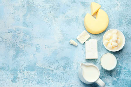 Different dairy products on color background