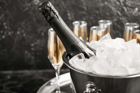 Bucket with ice and champagne on dark backgroundの写真素材