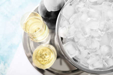 Bucket with ice and champagne on color backgroundの写真素材