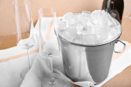 Bucket with ice and champagne on color backgroundの写真素材