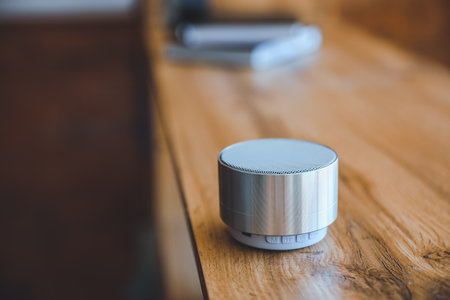 Smart home assistant device on table in roomの写真素材