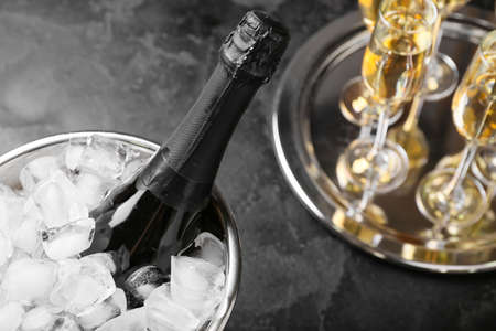 Bucket with ice and champagne on dark backgroundの写真素材
