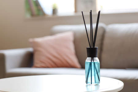 Reed diffuser on table in room