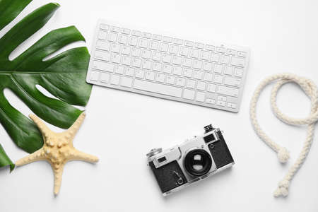 Computer keyboard with photo camera, rope and starfish on white backgroundの写真素材