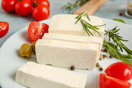 Tasty feta cheese with tomato and spices on plateの写真素材