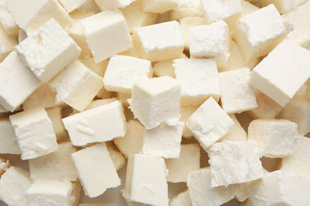 Tasty cut feta cheese as background