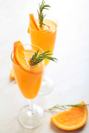 Glasses of tasty mimosa cocktail on tableの写真素材