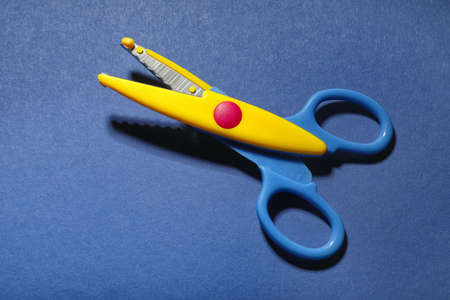 Scissors for paper on color background
