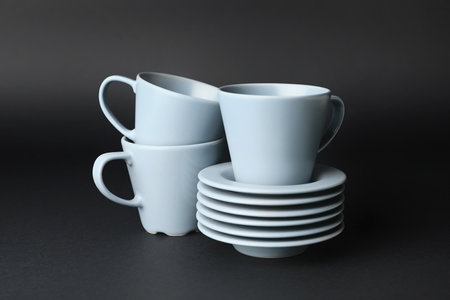 Empty cups and saucers on dark backgroundの写真素材