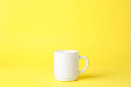 Empty cup on color backgroundの写真素材