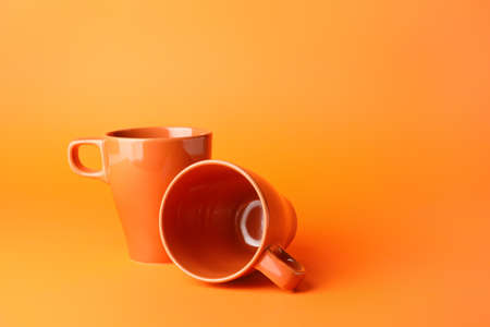 Empty cups on color backgroundの写真素材