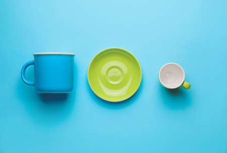Saucer and cups on color backgroundの写真素材