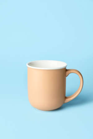 Empty cup on color backgroundの写真素材