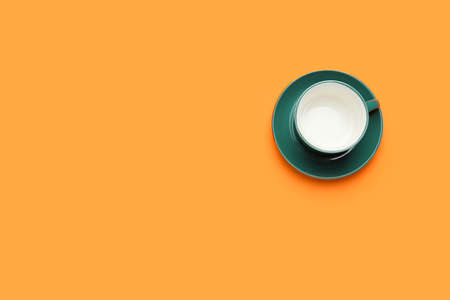 Empty cup on color background