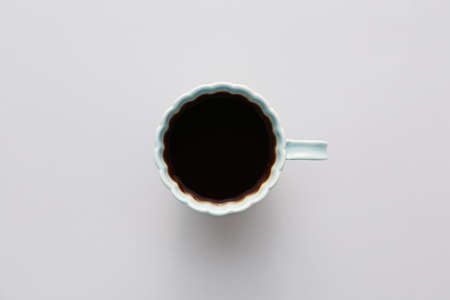 Cup of hot coffee on light background, top viewの写真素材