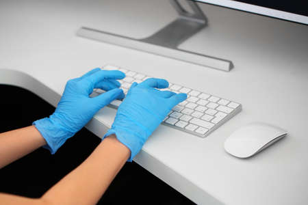 Female receptionist working at desk in clinicの写真素材