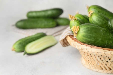 Bowl with green cucumbers on tableの写真素材