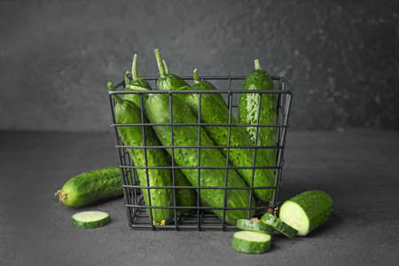 Basket with green cucumbers on dark backgroundの写真素材