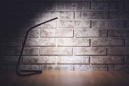 Glowing lamp on table in eveningの写真素材