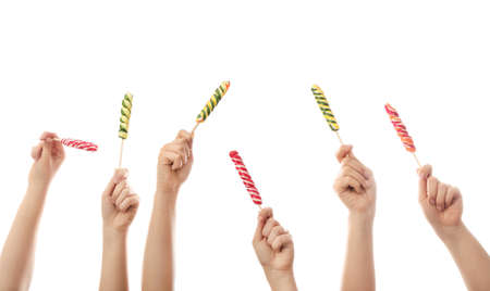 Hands with sweet lollipops on white backgroundの写真素材