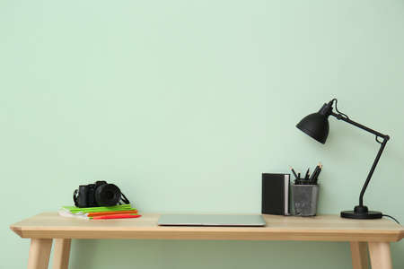 Stylish workplace of photographer near color wallの写真素材
