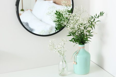Vases with flowers in modern bedroomの写真素材