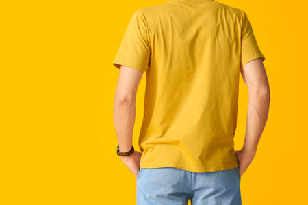 Man in stylish t-shirt on color backgroundの写真素材