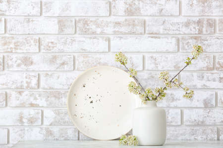 Vase with beautiful blooming branches on table in roomの写真素材