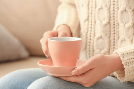 Woman with cup of tea at home, closeupの写真素材