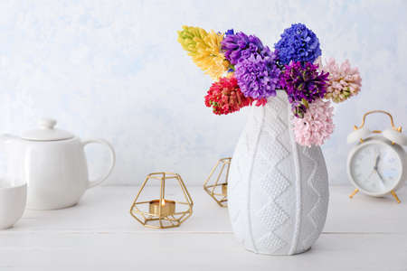 Vase with beautiful hyacinth flowers on tableの写真素材