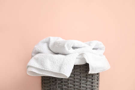 Basket with laundry near color wallの写真素材