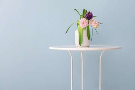 Vase with beautiful hyacinth flowers on table against gray backgroundの写真素材