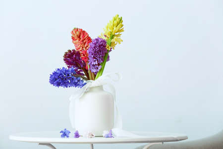 Vase with beautiful hyacinth flowers on table against gray backgroundの写真素材