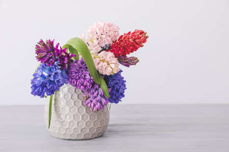 Vase with beautiful hyacinth flowers on tableの写真素材