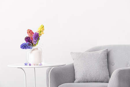 Vase with beautiful hyacinth flowers on table in roomの写真素材