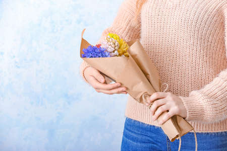 Woman with beautiful hyacinth flowers on light background, closeupの写真素材