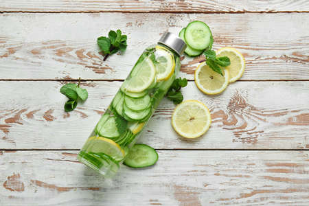Bottle of infused cucumber water on tableの写真素材