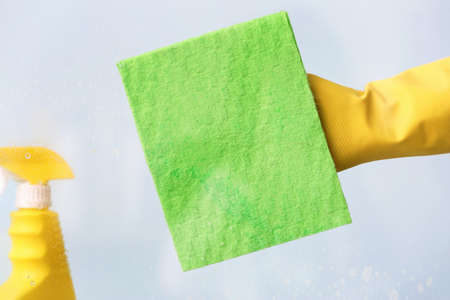 Housewife cleaning window at home