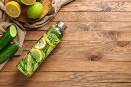 Bottle of infused cucumber water on tableの写真素材