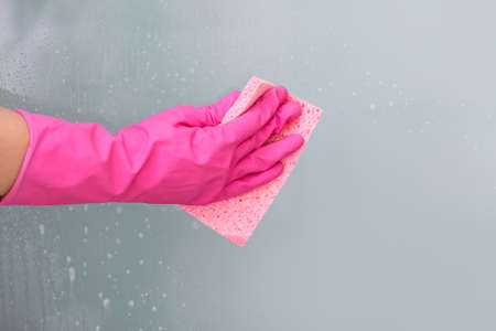 Housewife cleaning window at homeの写真素材