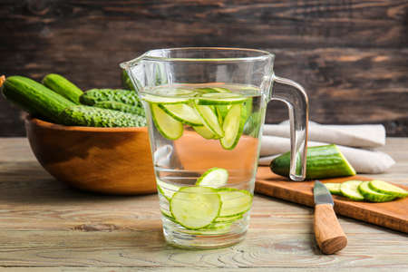 Jug of infused cucumber water on tableの写真素材