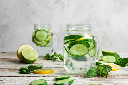 Mason jar of infused cucumber water on tableの写真素材