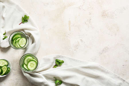 Glasses of infused cucumber water on light backgroundの写真素材