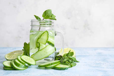 Mason jar of cucumber infused water on tableの写真素材