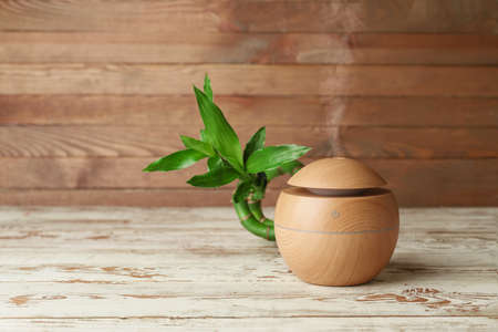 Aroma oil diffuser on wooden backgroundの写真素材