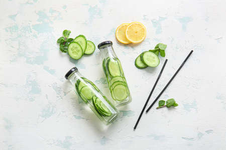 Bottles of cucumber infused water on tableの写真素材